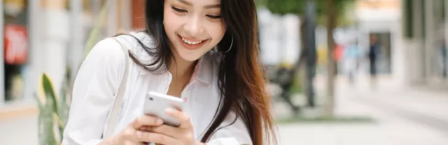 Woman smiling at phone
